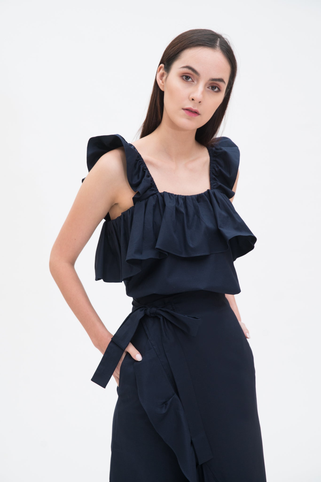 A woman is wearing a blue ruffled scrappy dress