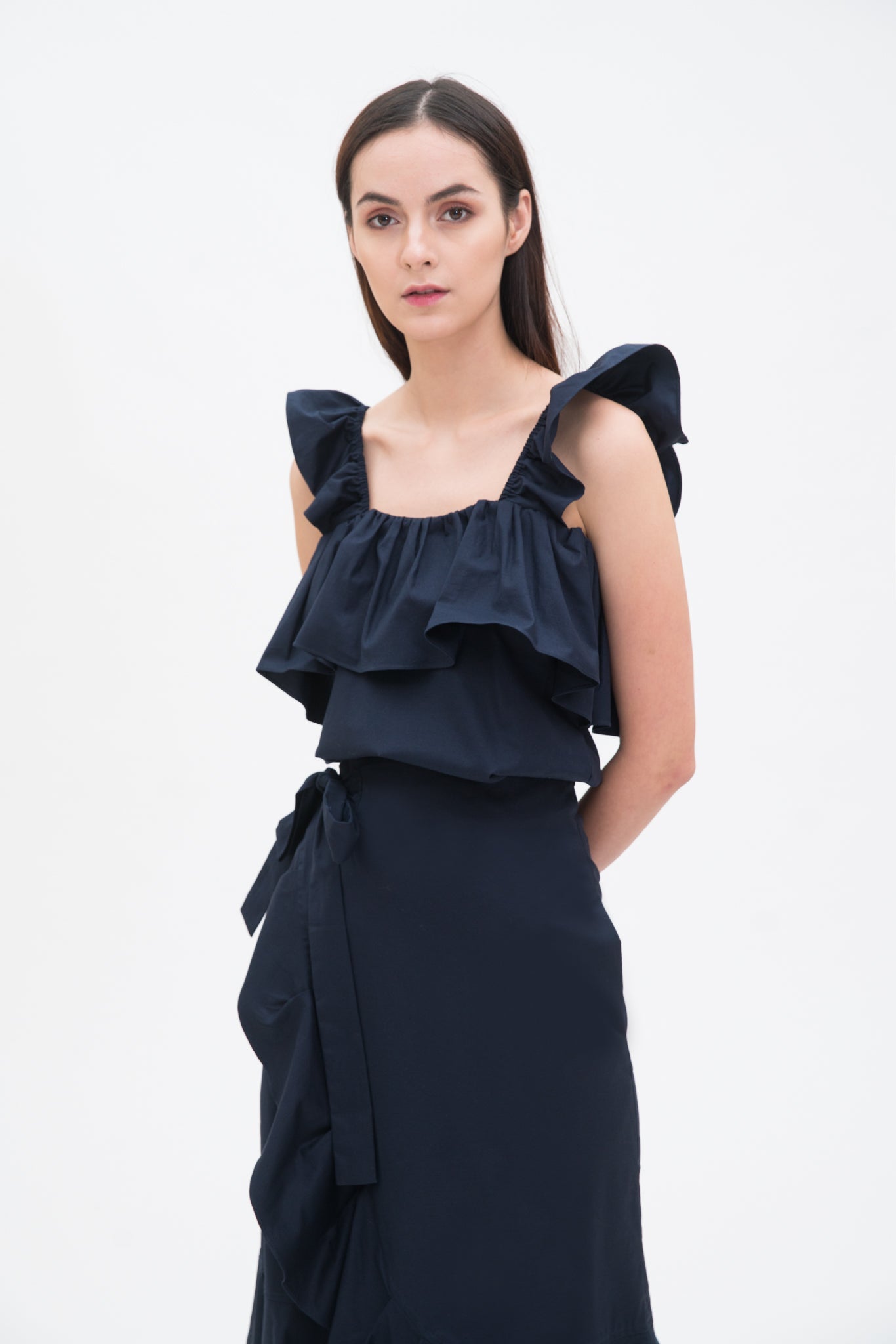 A woman is wearing a blue ruffled scrappy dress