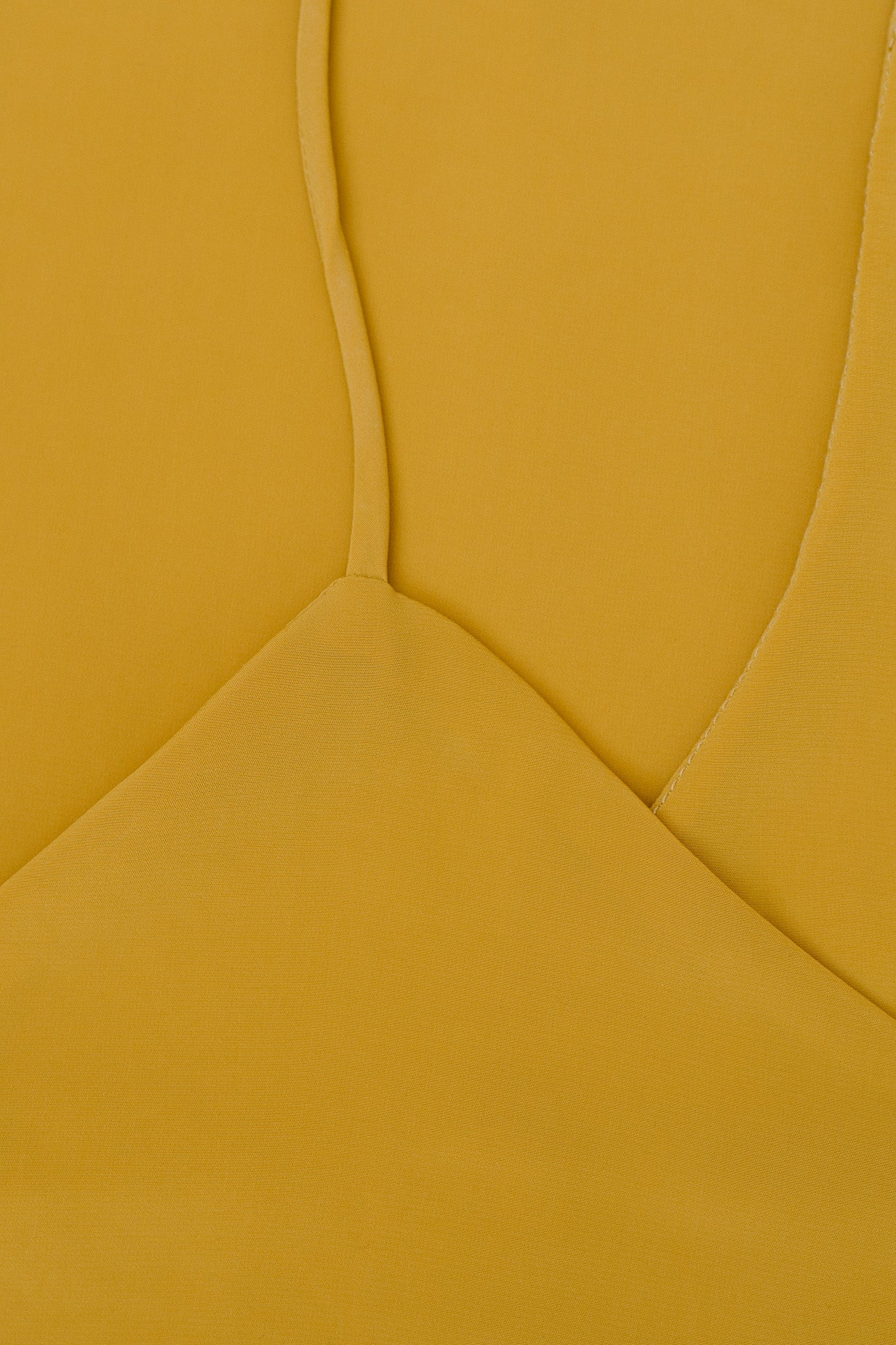 A closeup of a yellow dress