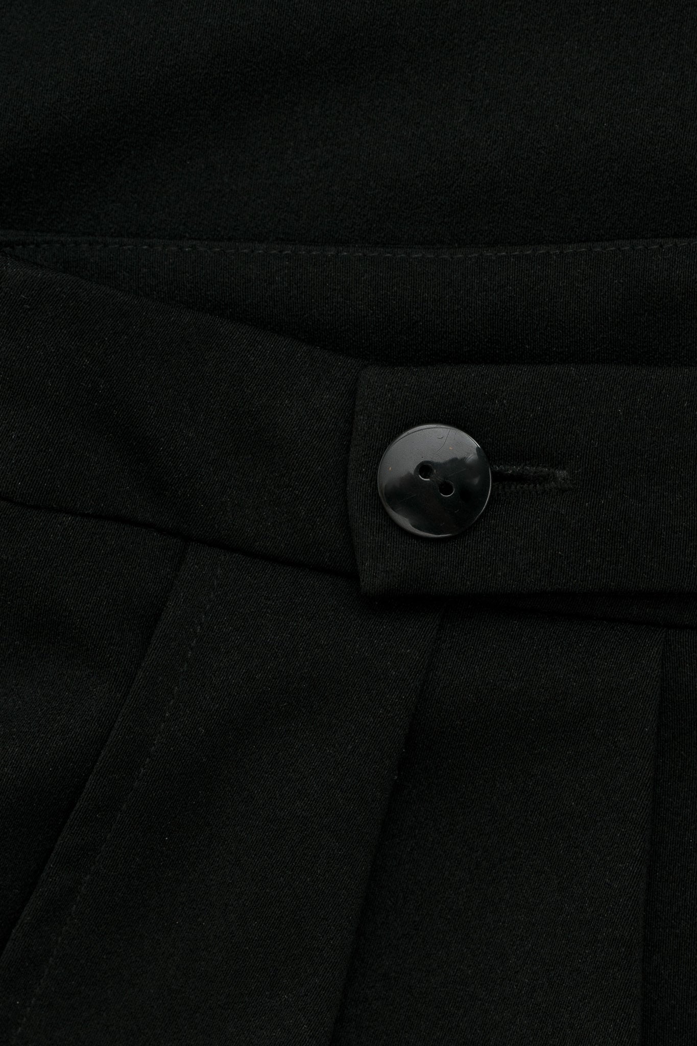 A close up of black fabric with a black button