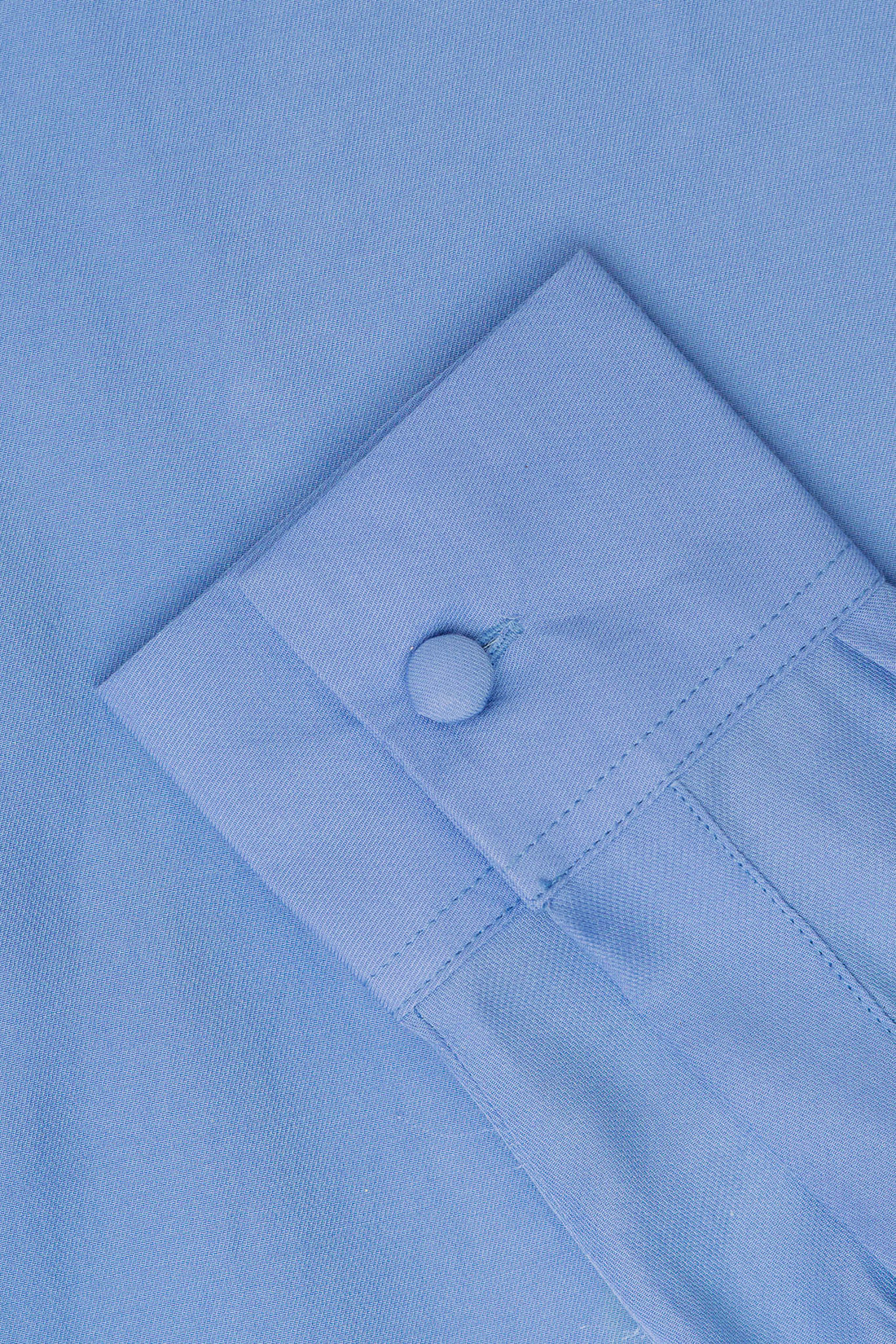 A close up of blue fabric and a blue button