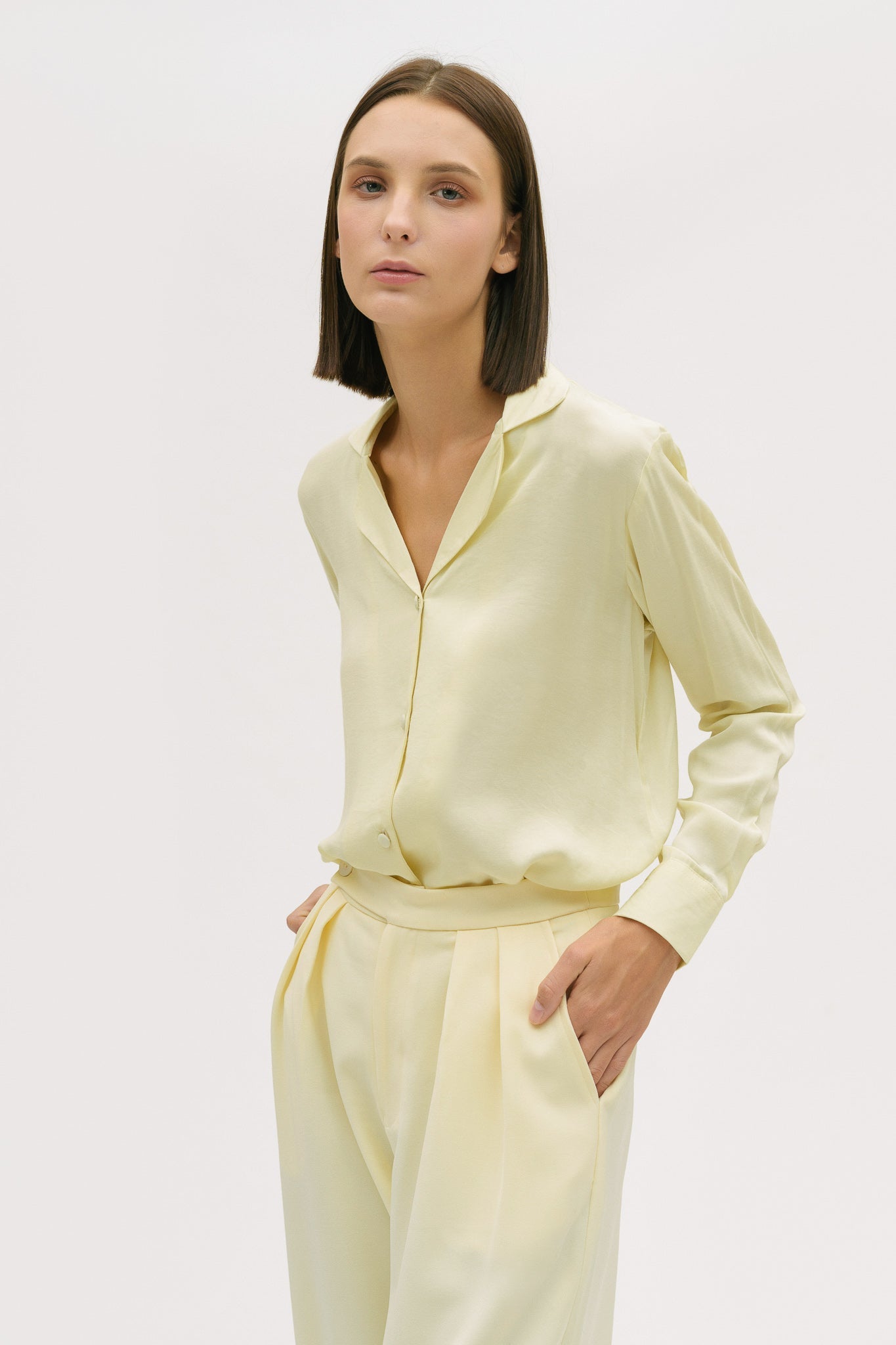 A woman is wearing a yellow shirt and yellow trousers.