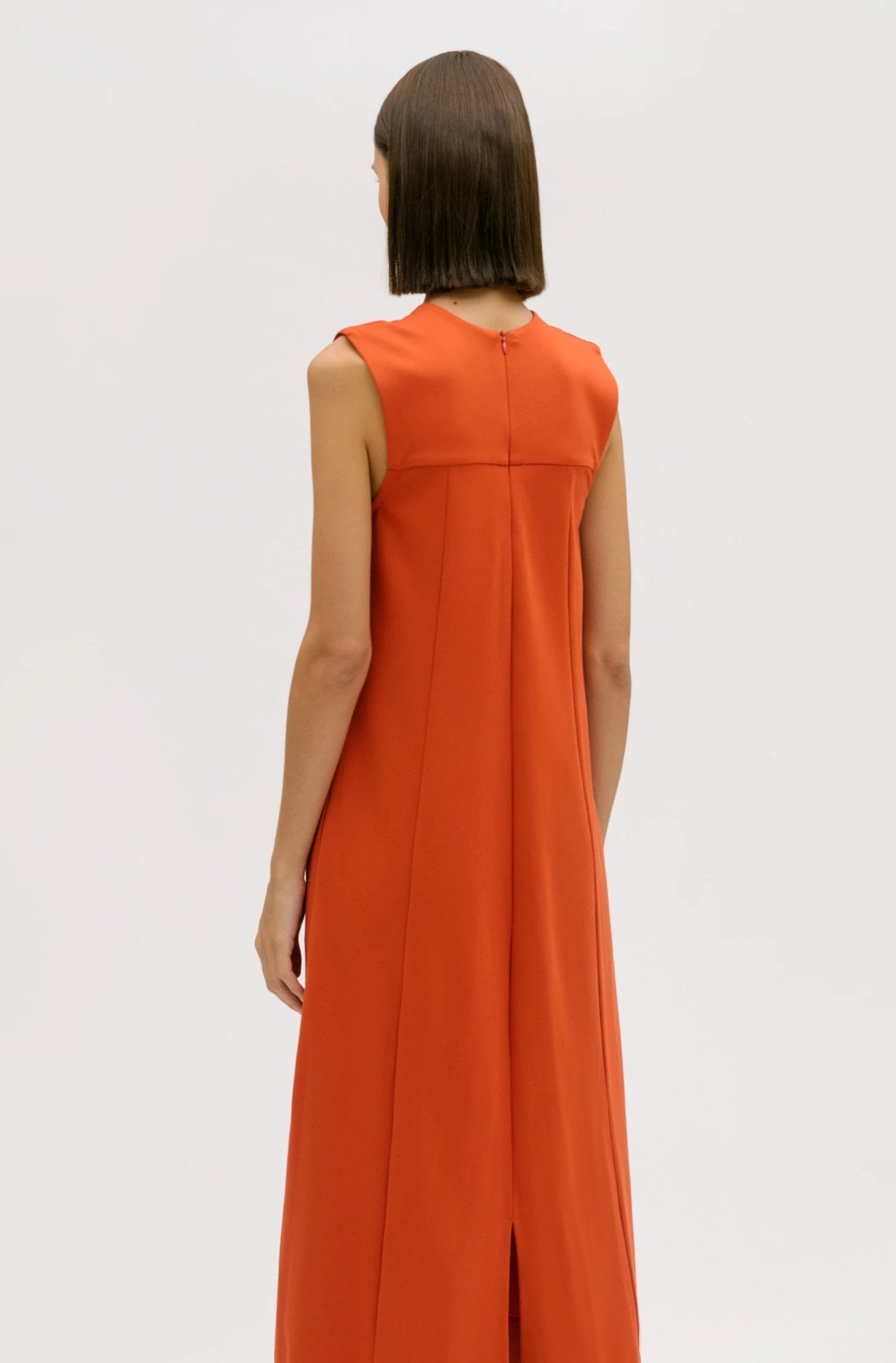A woman wearing an orange dress.