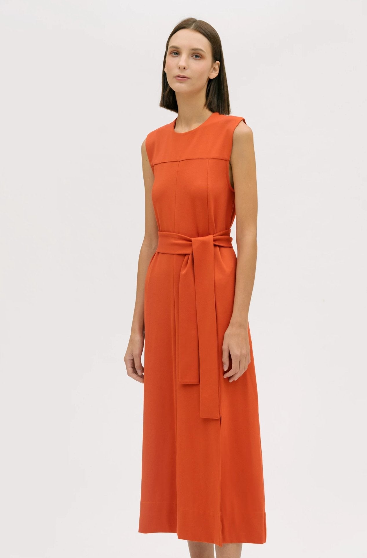 A woman wearing an orange dress.
