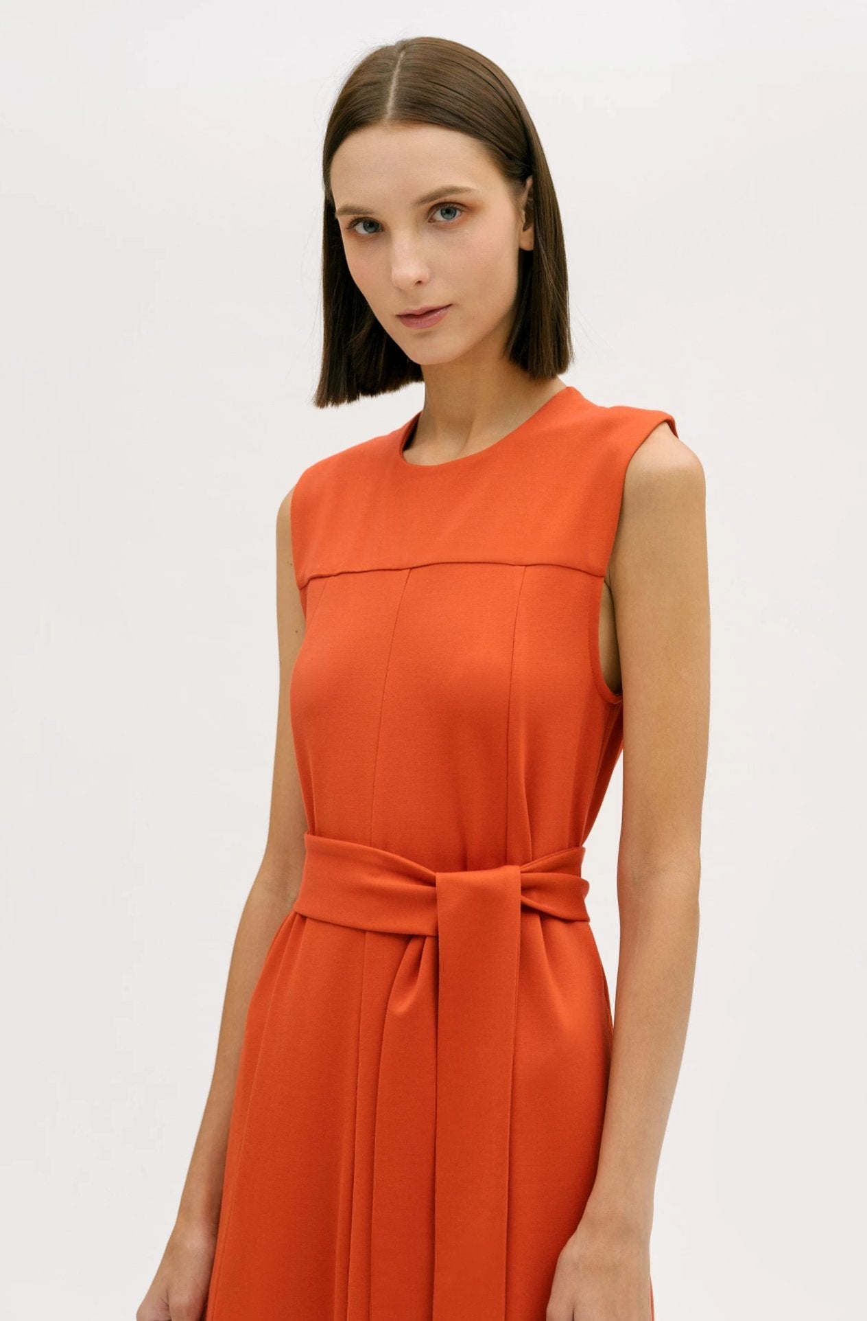 A woman wearing an orange dress.